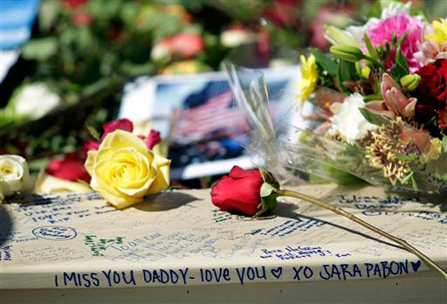 Photograph from last year: Mourners leave flowers, photos, and messages in memory of the victims of the 9/11 attacks